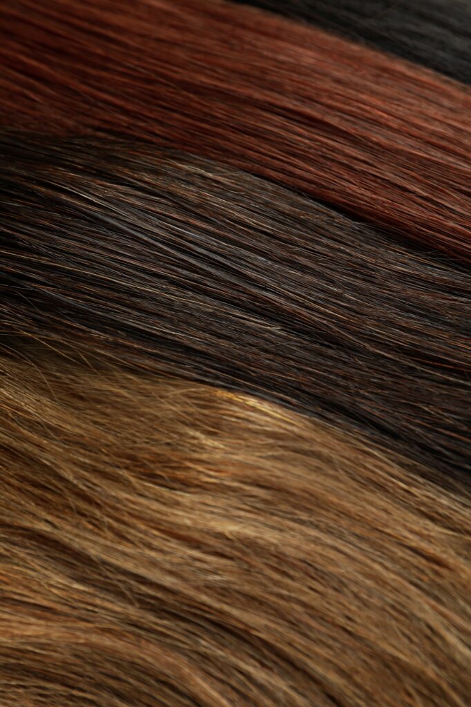 Different color female hair on whole background, close up